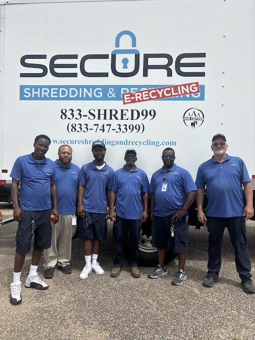 Secure Shredding and E-recycling truck drivers smiling during a mobile shredding service visit.