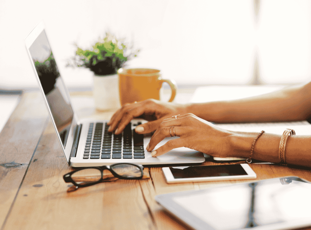 Person working on a laptop while securely accessing business information from a remote workspace.